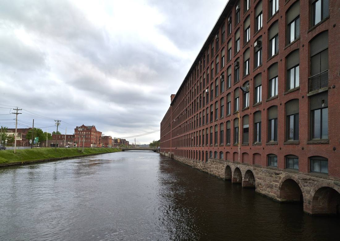 Old brick factory buildings along an industrial canal
